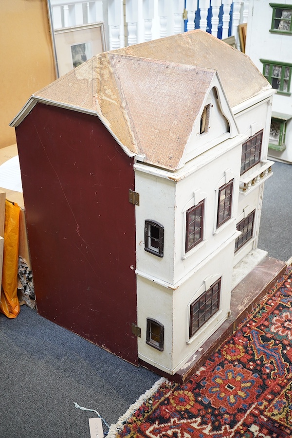 A large early 20th century J G Lines doll’s house, of plywood and tinplate construction, with two front opening sections and four internal rooms, 92cm high, 80cm wide, 60cm deep. Condition - fair